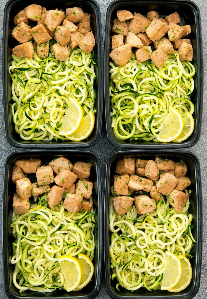 overhead photo of four containers with Lemon Garlic Chicken with Zucchini Noodles 