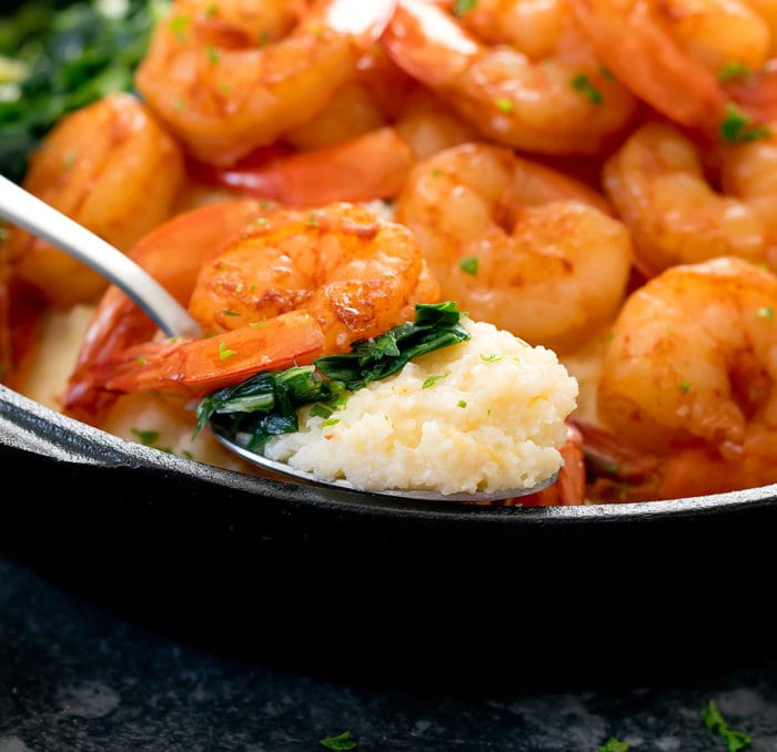 close-up photo of a spoonful of cauliflower grits with a shrimp