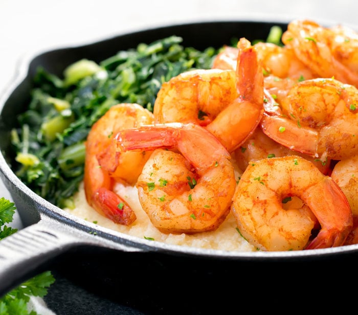close-up photo of shrimp and cauliflower grits in a skillet