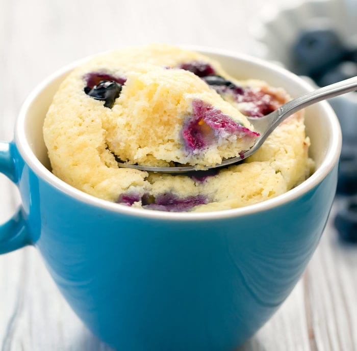 close-up photo of a spoon scooping some blueberry cake