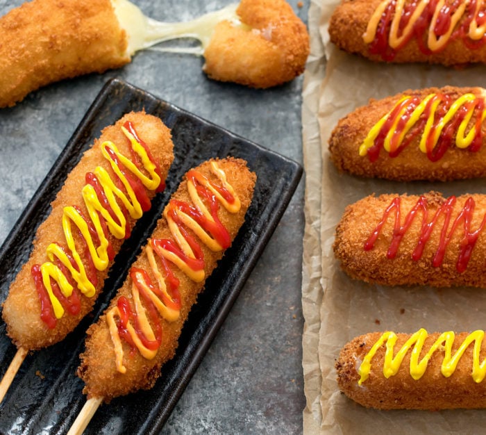 overhead photo of Korean Hot Dogs drizzled with ketchup and mustard