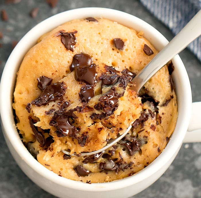 overhead photo of a Peanut Butter Chocolate Chip Mug Cake with a spoon