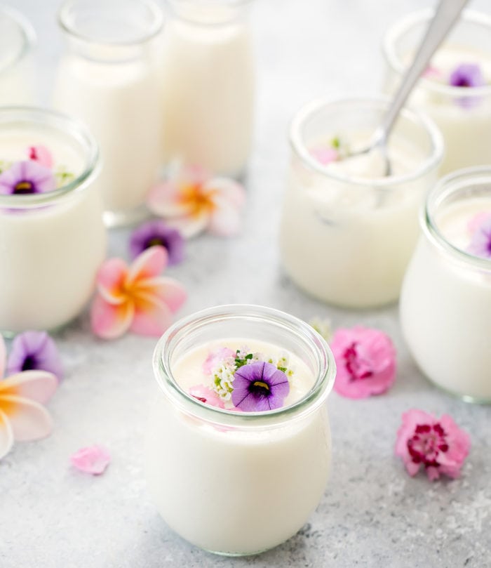 photo of milk pudding in a jar with more jars in the background