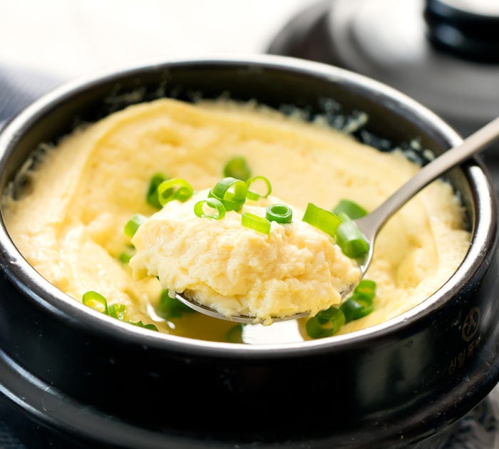 close-up photo of a spoon scooping so steamed eggs