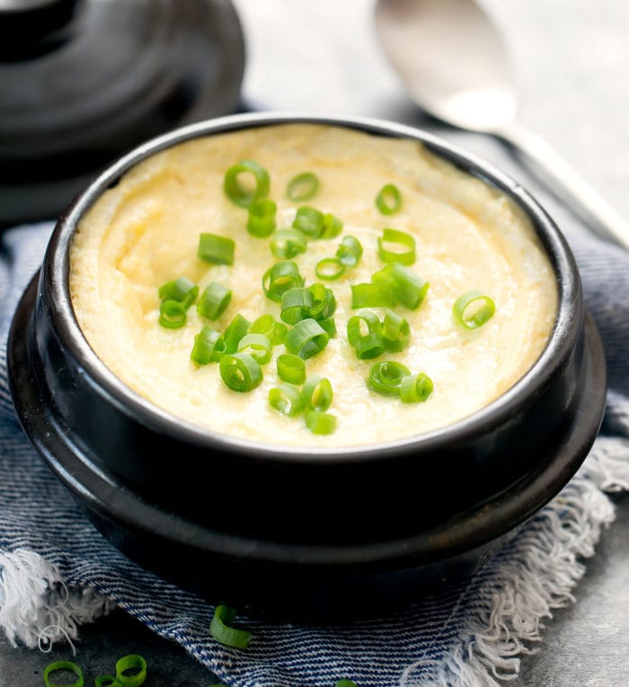 photo of steamed eggs in a bowl with sliced green onions