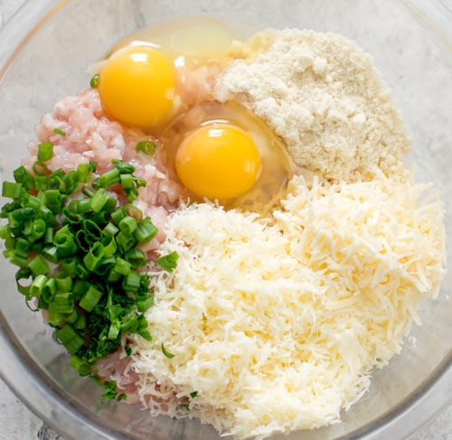 overhead photo of a bowl with the ingredients to make chicken fritters