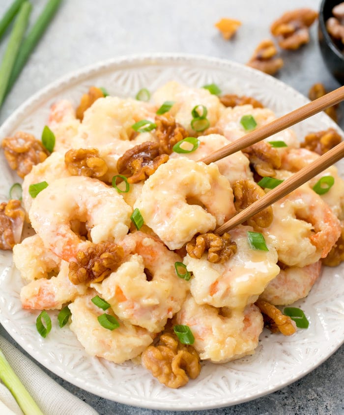 photo of chopsticks holding a piece of walnut shrimp
