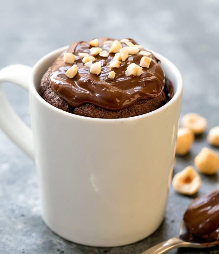 photo of a nutella mug cake garnished with hazelnuts