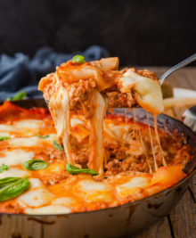 photo of skillet lasagna being scooped out of the pan
