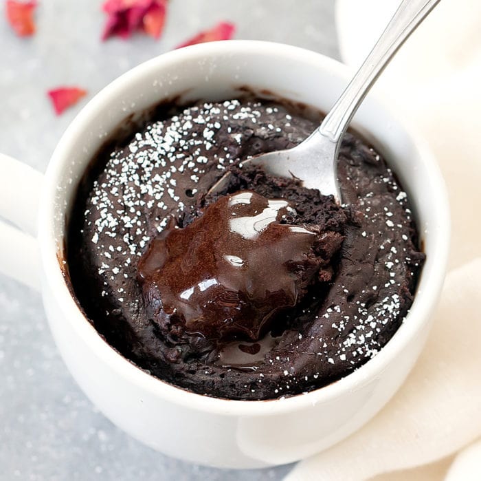 overhead photo of spoon dipping into a chocolate lava mug cake