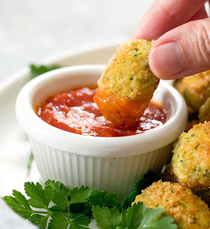 photo of a tot being dipped in sauce