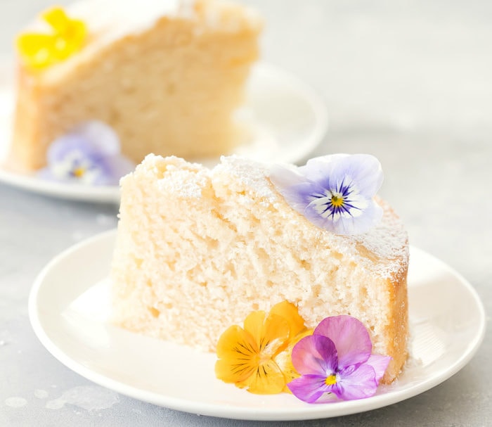 photo of a slice of cake garnished with fresh flowers