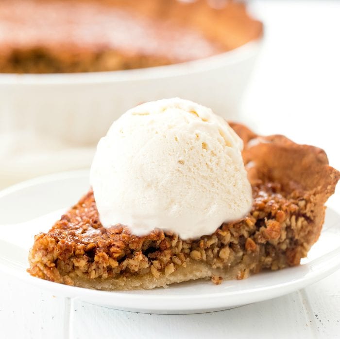 a slice of pie topped with vanilla ice cream