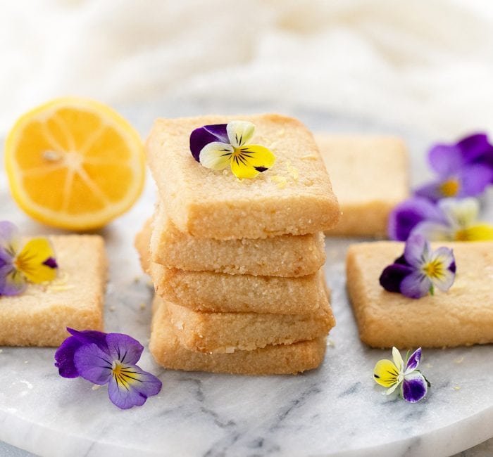 a stack of cookies garnished with fresh flowers.