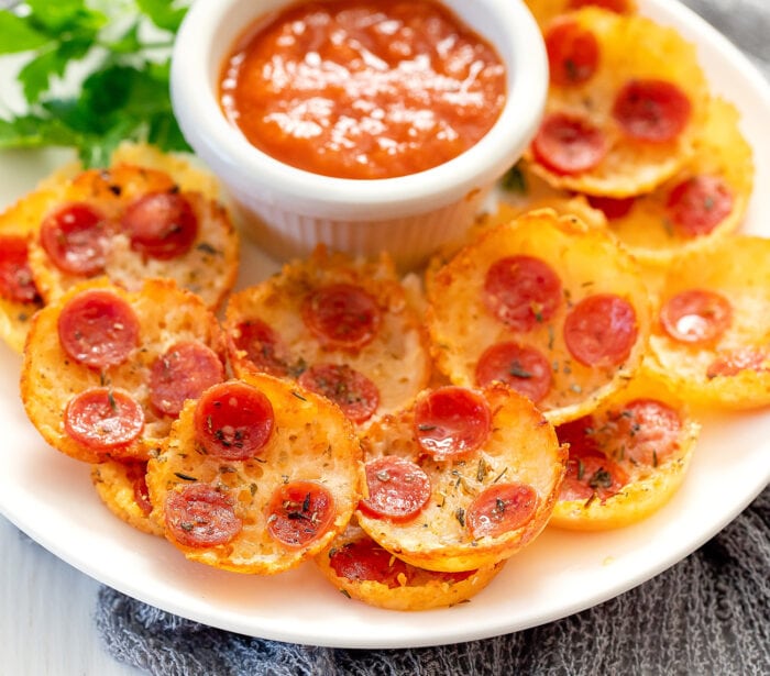 pizza chips on a platter with dipping sauce.