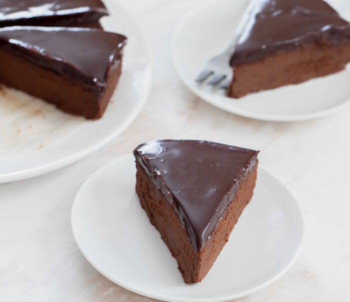 slices of chocolate cake on white plates.
