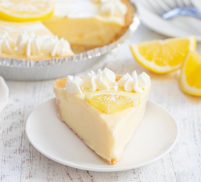 a slice of no bake lemon pie on a plate.