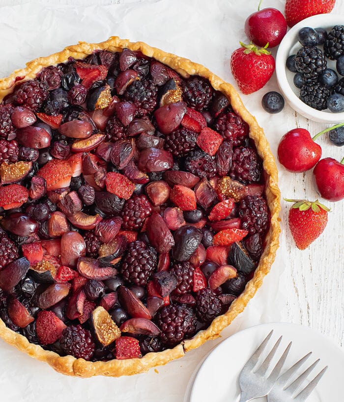 a whole tart made with berries and cherries.