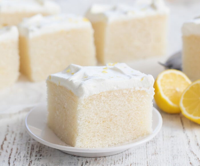 a slice of lemon cake on a small white plate.