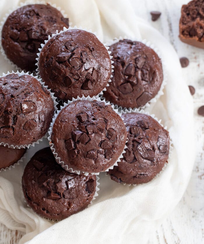 Chocolate muffins stacked on top of each other.
