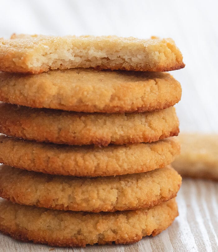 a stack of cookies with a bite taken out of the top one.