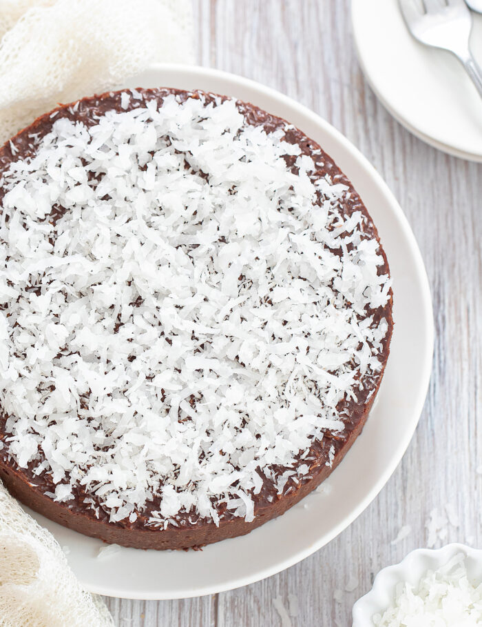 a no bake coconut cake topped with shredded coconut.