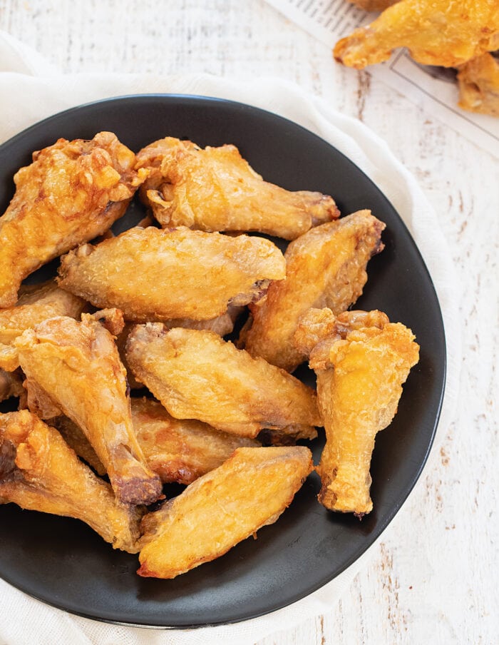 a plate of crispy chicken wings.