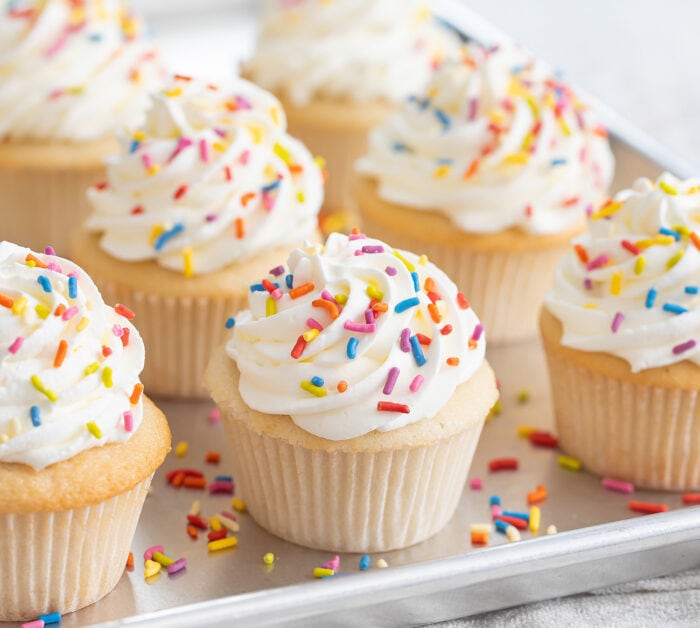 frosted cupcakes on a sheet pan.