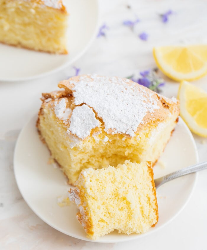 lemon cake on a plate with a fork.