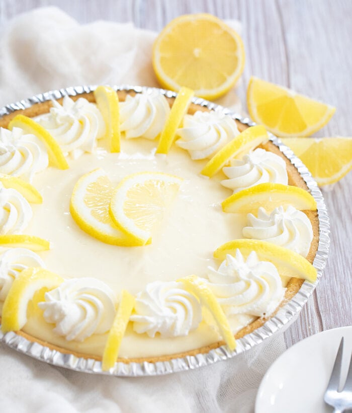 a whole no bake lemon pie garnished with lemon slices.
