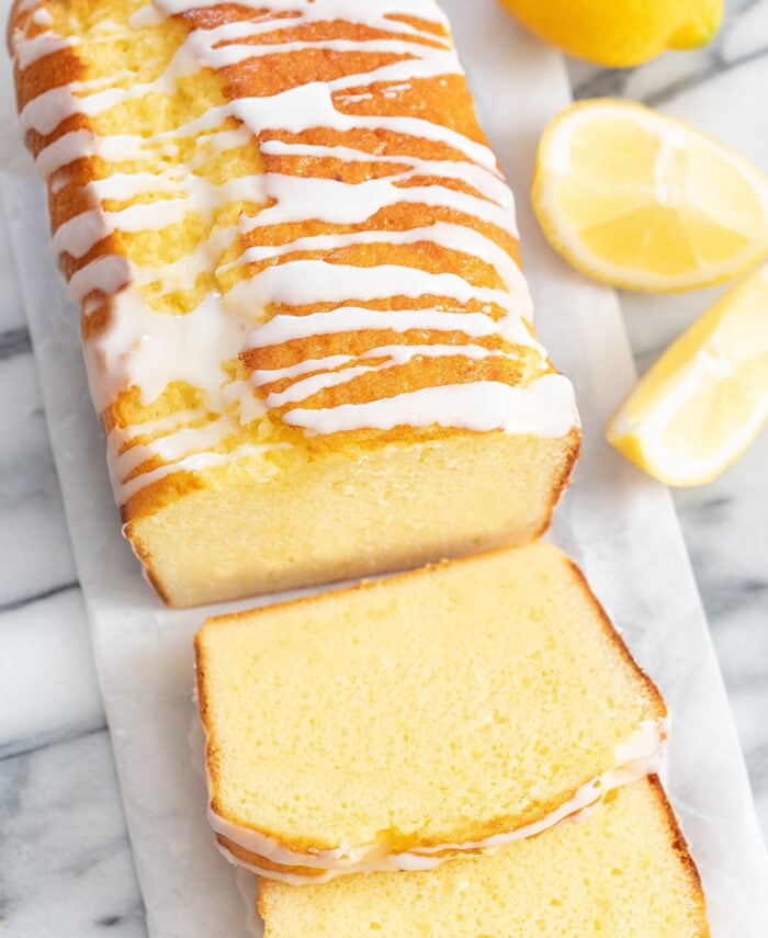 a sliced lemon pound cake topped with glaze.