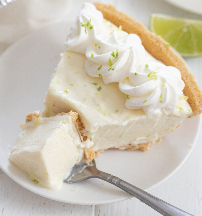 a slice of key lime pie on a plate with a fork.