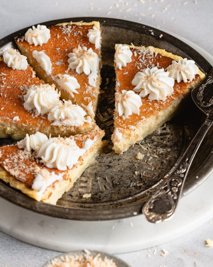 sliced of coconut pie in a pan.