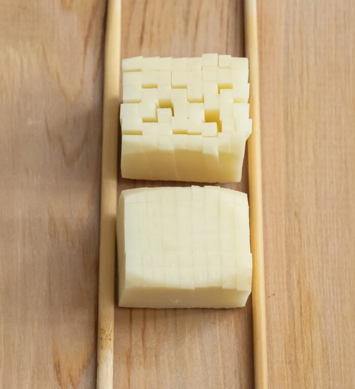 potato cubes being sliced.