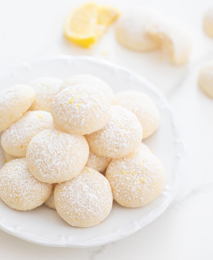  a plate of lemon melting moments dusted with powdered sugar.