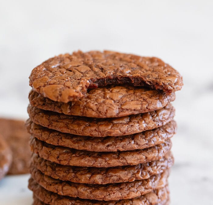 a stack of cookies with a bite taken out of the top one.