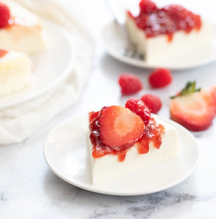 a slice of cheesecake topped with strawberries.