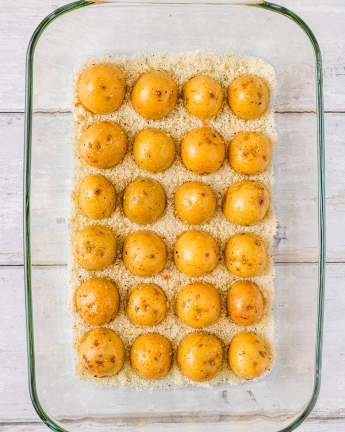 the potatoes in the baking dish on top of parmesan cheese.
