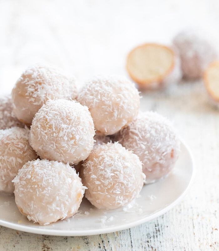 a plate of coconut donuts.