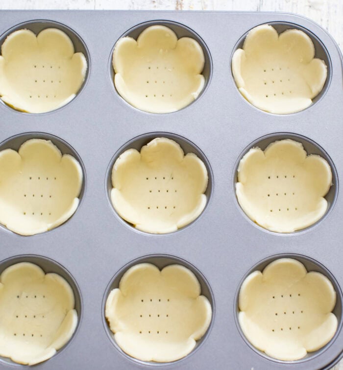 Flower shaped pie crusts in a muffin pan