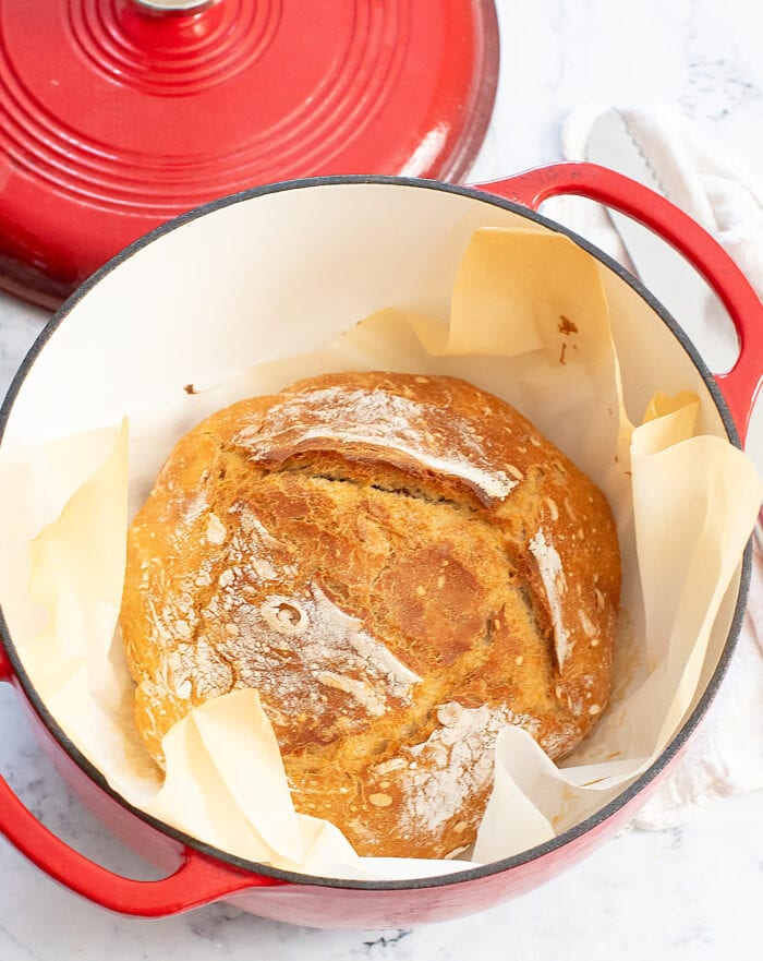 A loaf of artisan bread in a Dutch oven