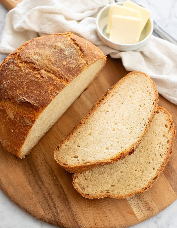 An artisan bread loaf with two slices cut