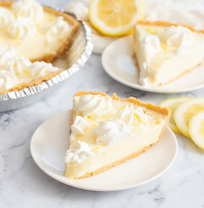 Slice of lemon pie with whipped cream on top 