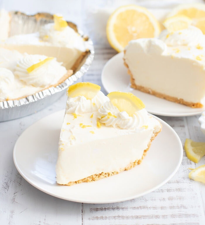 A slice of lemon cream pie on a white plate