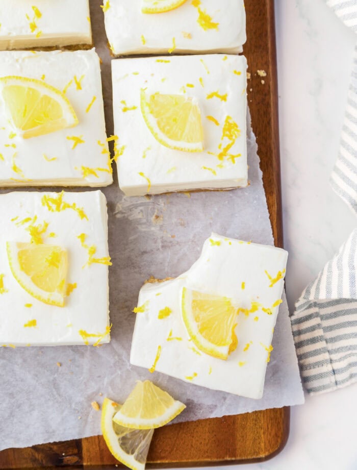 Lemon bars on a wood serving board