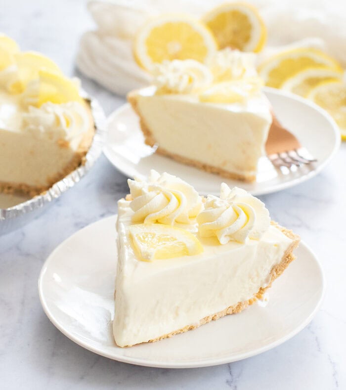 Slice of lemonade pie on a white circle plate