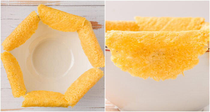 Parmesan cheese taco shells draped over the edge of a large bowl