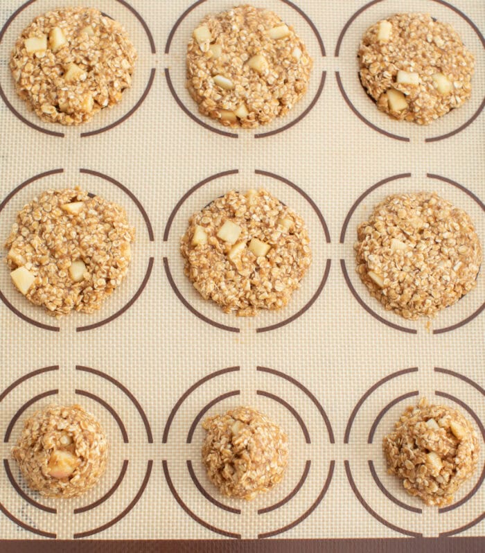 1.5 tablespoon cookie dough round disks flattened on a baking sheet