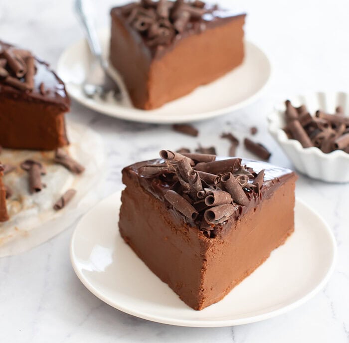 A slice of no bake chocolate cake on a small white plate