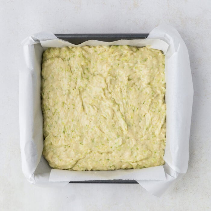 zucchini cake batter in a baking pan